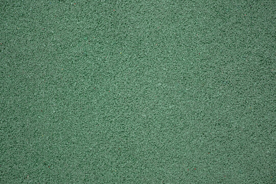 Green EPDM rubber crumb flooring texture. Seamless protective surface background pattern for outdoor kids playground or sports court.