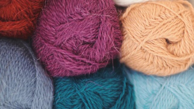 A collection of colorful yarn balls in various sizes, ideal for use in craft projects or as a decorative element