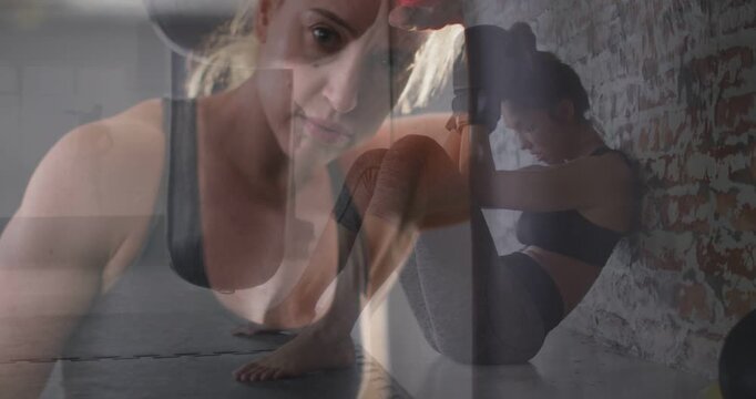 Trainer leaning to camera raising wrapped fist, crossfading to trainee doing core reps for fitness