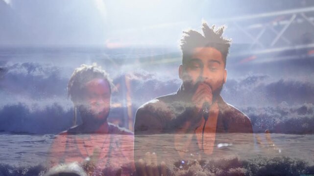 Ocean overlay starting lead singer singing and gesturing while bandmate backing creating mood