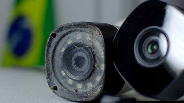 Security Camera - Detail of an old and modern security circuit camera, side by side on a white background, representing the evolution of surveillance.