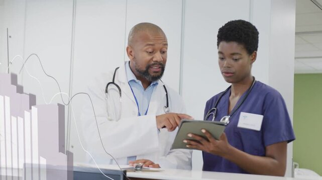 Doctor pointing and tapping tablet as nurse holding tablet, graphs on screen, reviewing health data