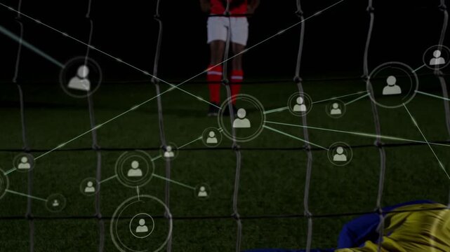 Striker kicking ball outside box seeking goal, GK diving saving, tech network spreading over GK or n