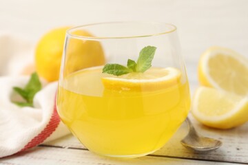 Fototapeta premium Tasty lemon jelly served with mint on white wooden table, closeup
