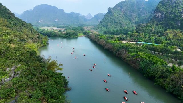 Aerial view of Trang An scenic area with boat cave tours near Ninh Binh, Vietnam.