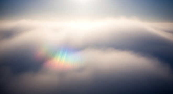 sunlight shining through clouds with rainbow effect