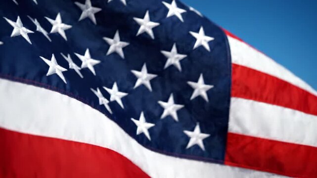 extreme close-up of american flag waving against blue sky
