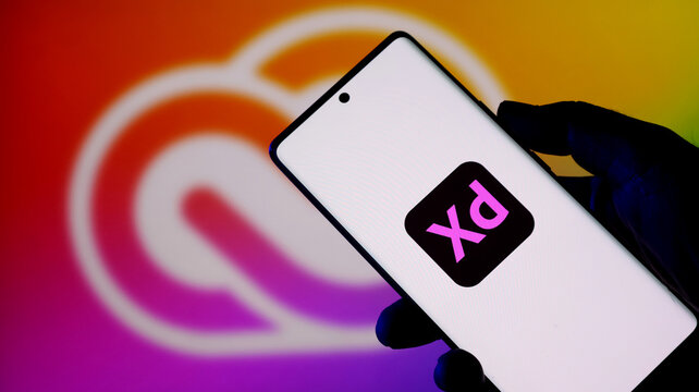 Adobe xd app icon displayed on a modern smartphone screen with a colorful background