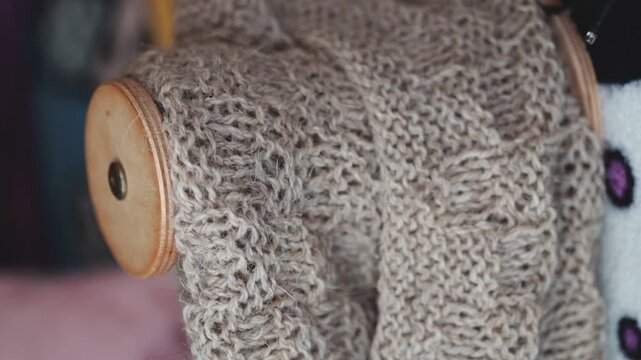 Close-up shot of a knitted sweater with a wooden button