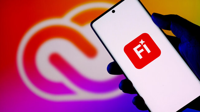 Hand holding a smartphone displaying the fi app logo against a colorful background
