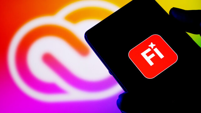Closeup of a smartphone displaying the adobe firefly app icon with a colorful background