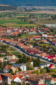 Aerial view of the town center with hills, buildings, streets, vegetation and surroundings in Rupea, Romania, 2021