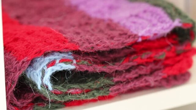 Close-up shot of a stack of blankets stored on a shelf