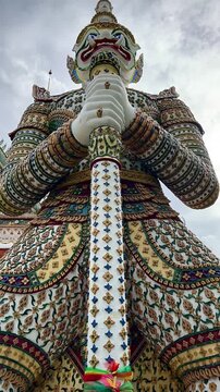 Colorful Demon Guardian Statue Holding Staff With Rainbow Fabric (Bangkok, Thailand)