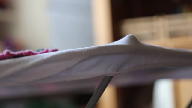 A detailed view of a piece of cloth being ironed