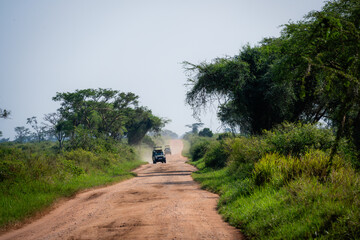 Safari jeeps driving on a dirt road in the african wild © Janica