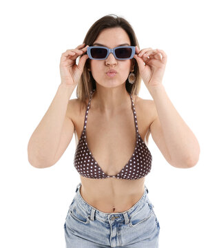 Beautiful woman wearing stylish swimsuit and sunglasses on white background