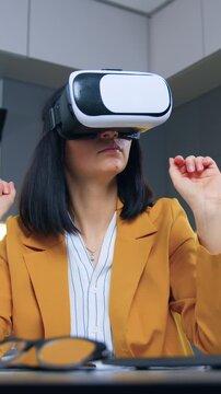 Modern technology concept where good-looking cvalified successful considerate 35-aged businesswoman in formal wear working at home on imaginary screen in augmented reality goggles