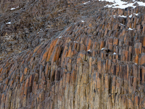 Basalt Column Rock Formation Cliffs With Snow Patches On Rugged Mountainside In BC, Canada