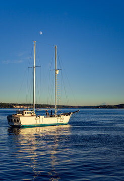 Sailboat on Puget Sound near Port Townsend Washington early morning with the moon