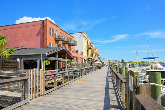 Rustic early American themed shops and cafes along the waterfront Harborwalk on the Sampit River in the historic district of Georgetown, South Carolina.