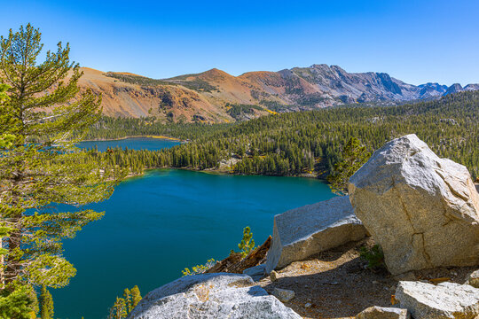 A stunning high-altitude perspective overlooking the deep blue waters of Lake George and Lake Mary surrounded by dense pine forests.