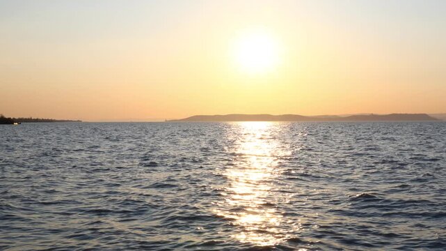 sunlit waves moving across lake balaton surface during sunset with golden reflections forming shifting patterns on calm water in wide natural view of hungarian landscape