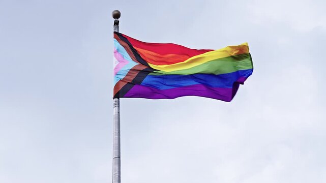 LGBT community. Tolerance and equality. World gay pride. Rainbow gay flag. Pride month. LGBTQ rainbow flag. LGBT rainbow flag waving against sky. Symbol of pride and LGBTQ. Colorful pride flag
