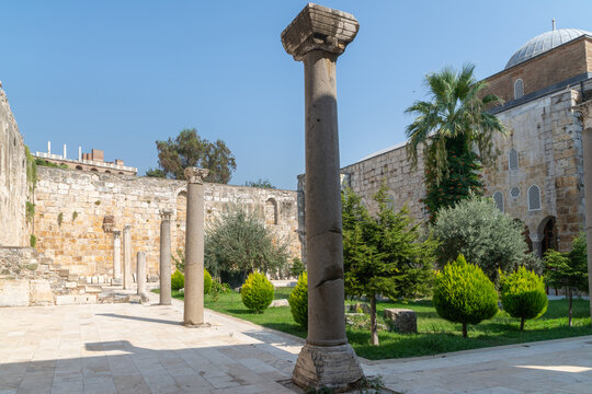Historic courtyard with ancient stone columns at Isa Bey Mosque in Selcuk, Turkey.
