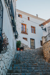 Spain, Altea city. Whitewashed buildings with balconies and stone steps leading up in a picturesque village in southern Spain during a clear day © JuLady_studio
