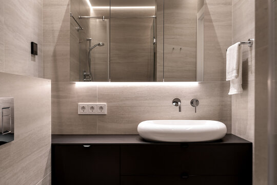 Bathroom in contemporary style with tiled walls