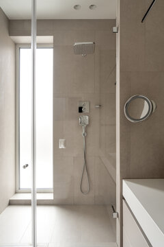 Bathroom in contemporary style with tiled walls