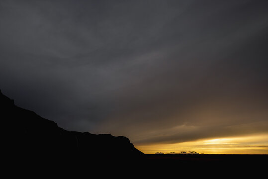 Dramatic Icelandic Sunset Over Silhouetted Mountains and Islands