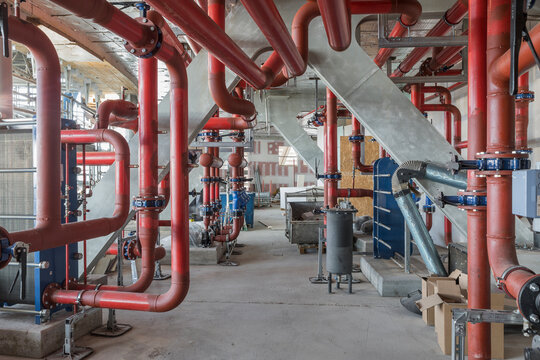 Industrial interior with red pipes in a mechanical room

