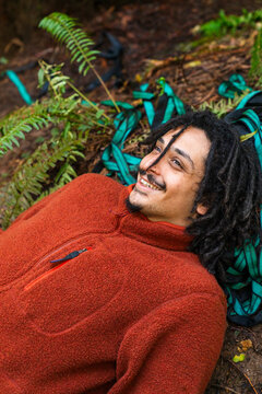 Portrait of man in forest with dreadlocks 