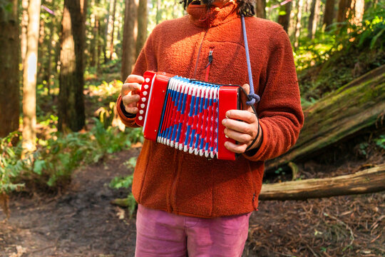 Man playing accordion outside