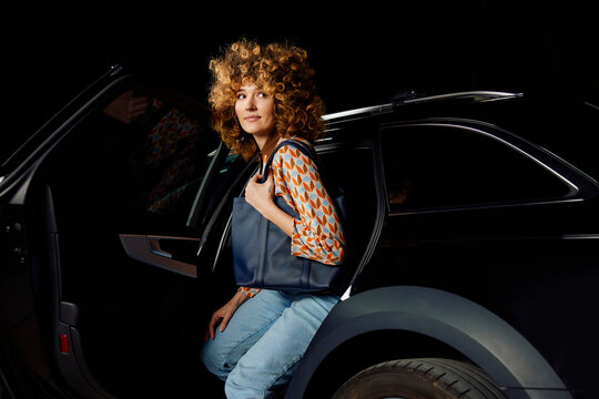 Casual woman gets out of the car