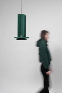 Woman's silhouette in motion and geometrical lamp