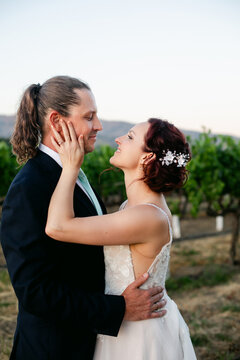 A Romantic Portrait of a Bride and Groom in a Vineyard at Sunset