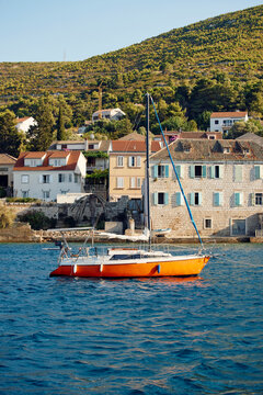 Sailboat anchored in a Mediterranean coastal town