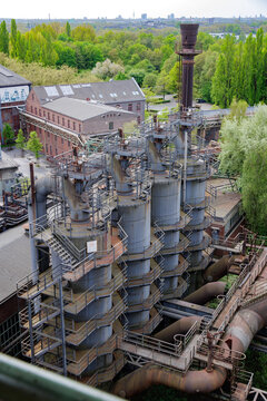 Elevated Perspective Of Decommissioned Industrial Site Surrounded By Natural And Urban Elements