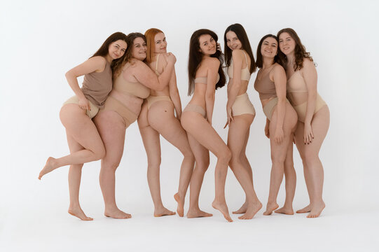 a group of happy female friends in underwear