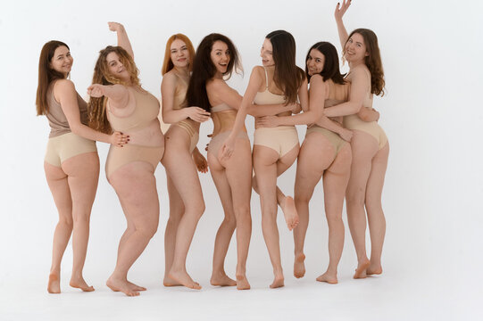 a group of happy female friends in underwear