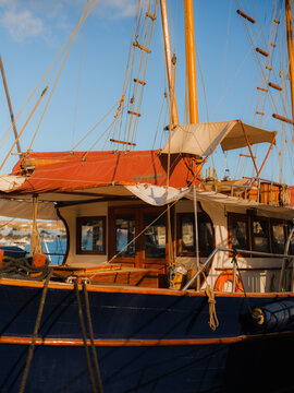Orange sailboat on the background of blue sky 