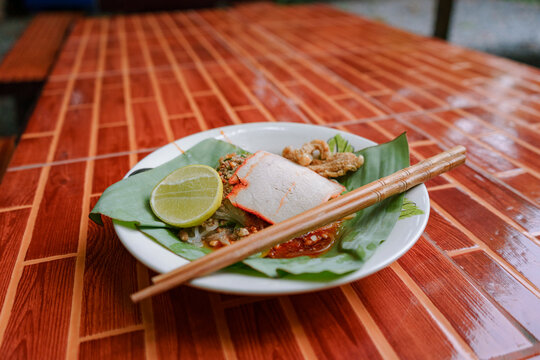 Thai Sukothai heritage noodles served on a banana leaf with chopsticks