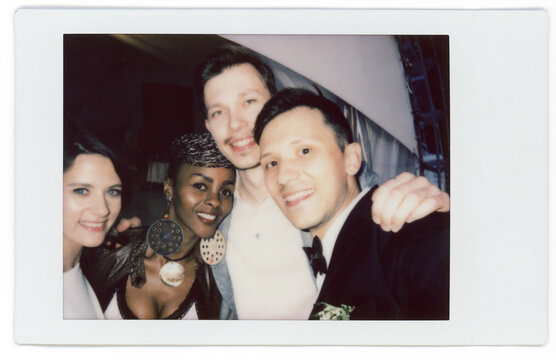 Friends celebrating wedding with groom and bride 