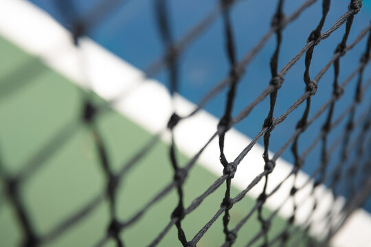 Close-Up Details of a Tennis Net on a Hard Court