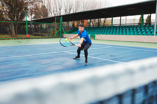 Tennis Player Returning Shot with Focused Intensity