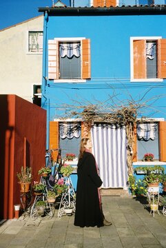 A portrait in front of a Vibrant Burano House 