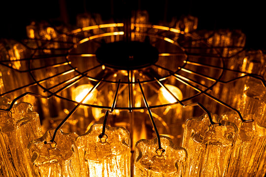 Modern luxury chandelier with glass crystals and metal frame close up